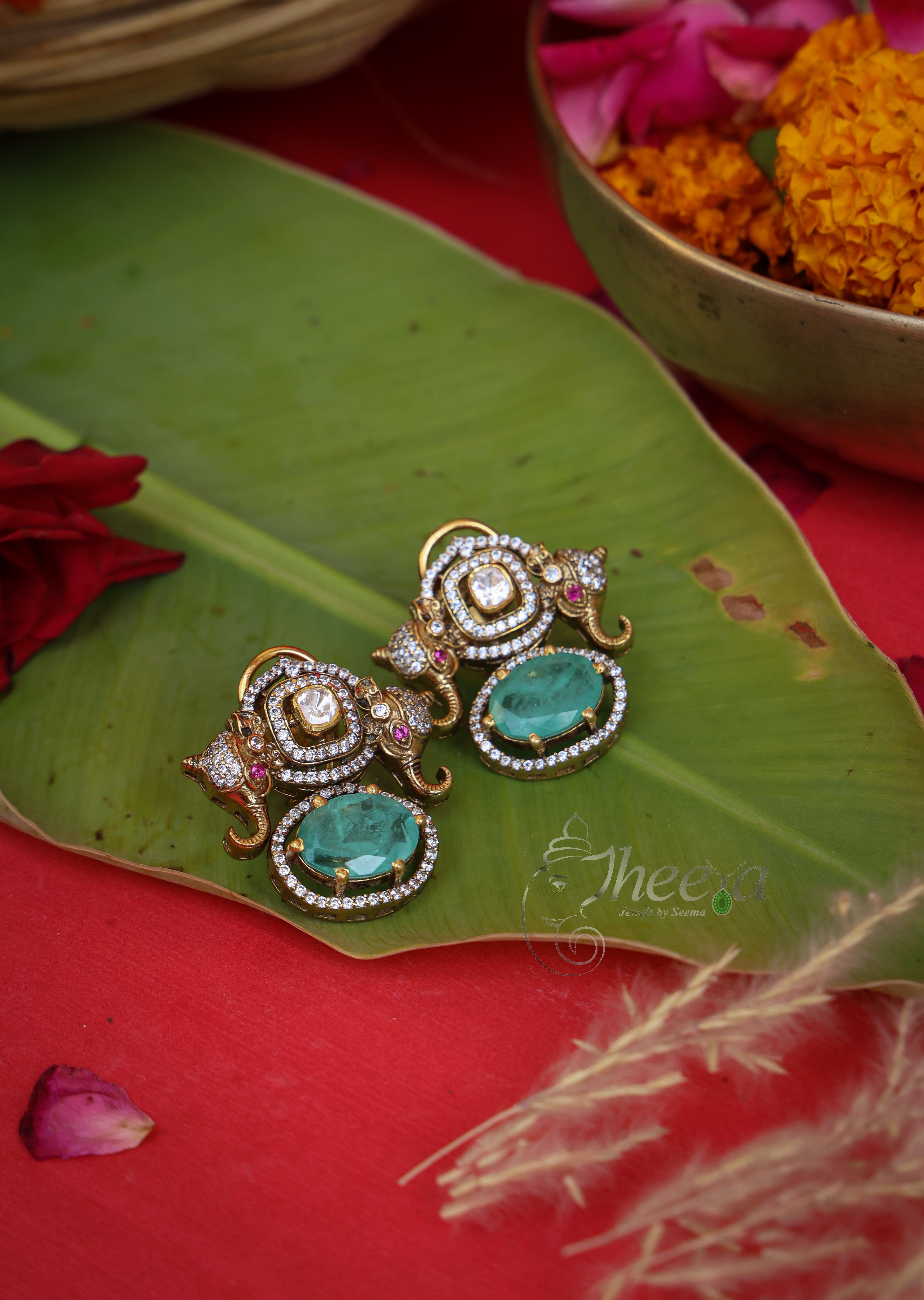 Rajkumari Mini Mint Elephant Studs in Pure Silver with green accents, front view.